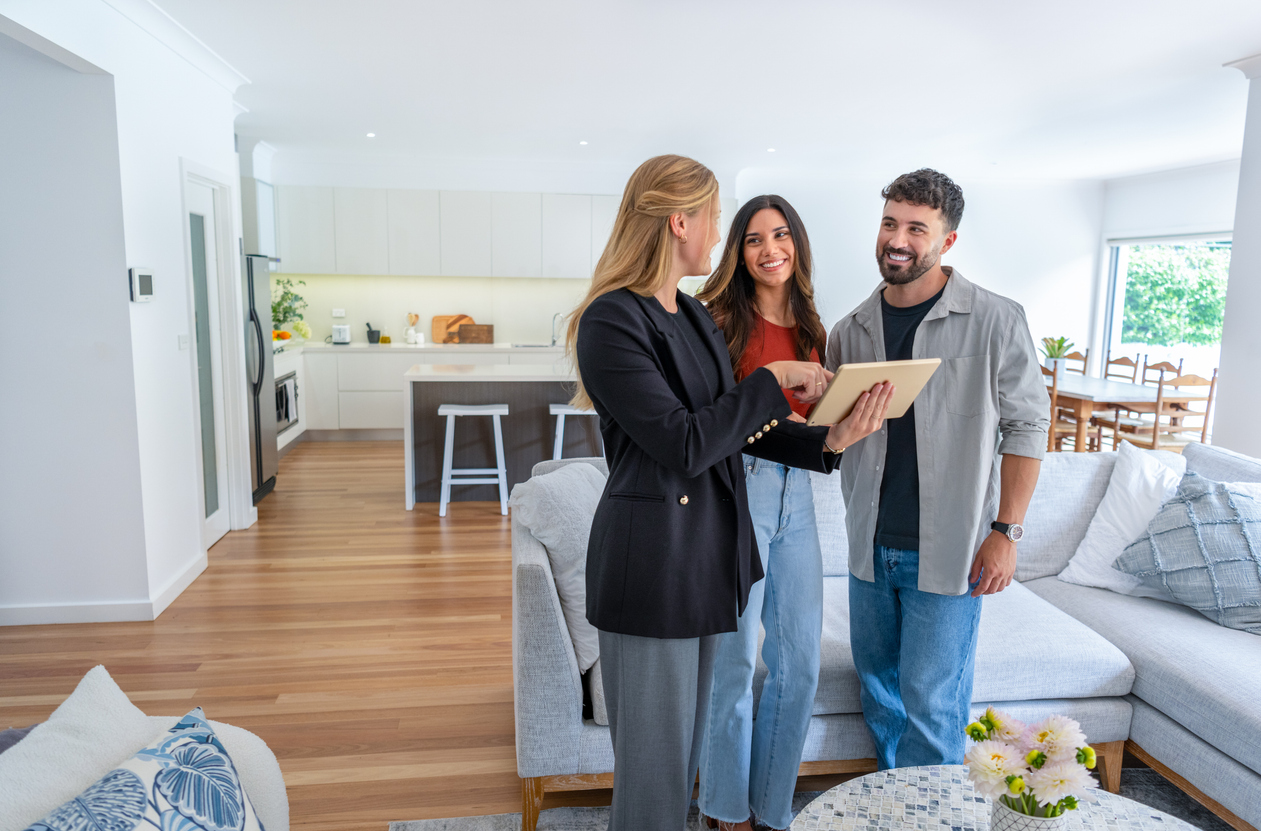 Real estate agent showing a couple a new home.